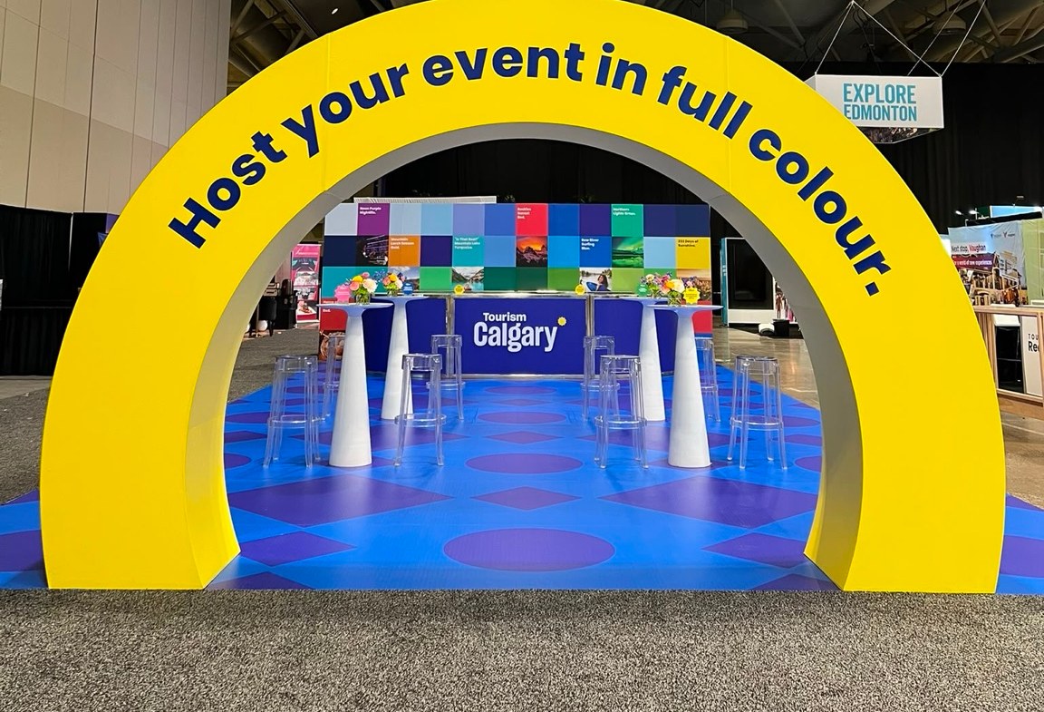 Large-format printed arch over a custom printed floor, with a branded counter and backdrop wall, installed at an event