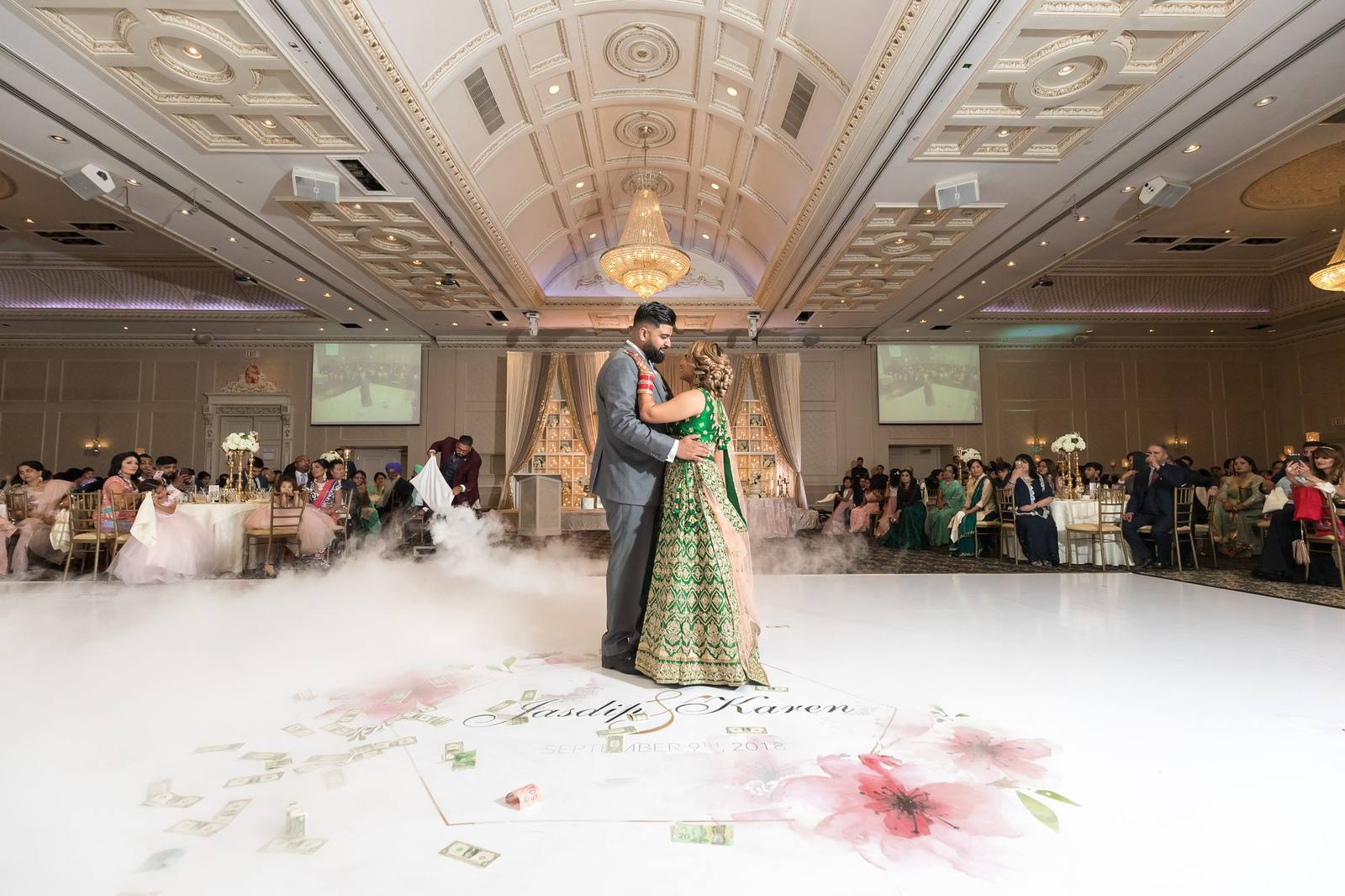 Couple sharing a first dance on a custom printed floral dance floor