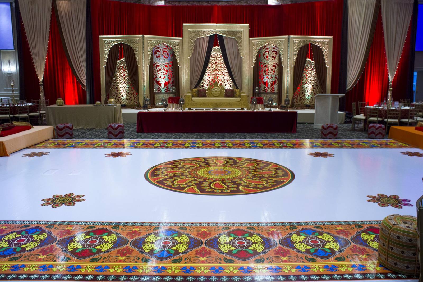 A white printed dance floor with a full-colour central medallion and patterned border.