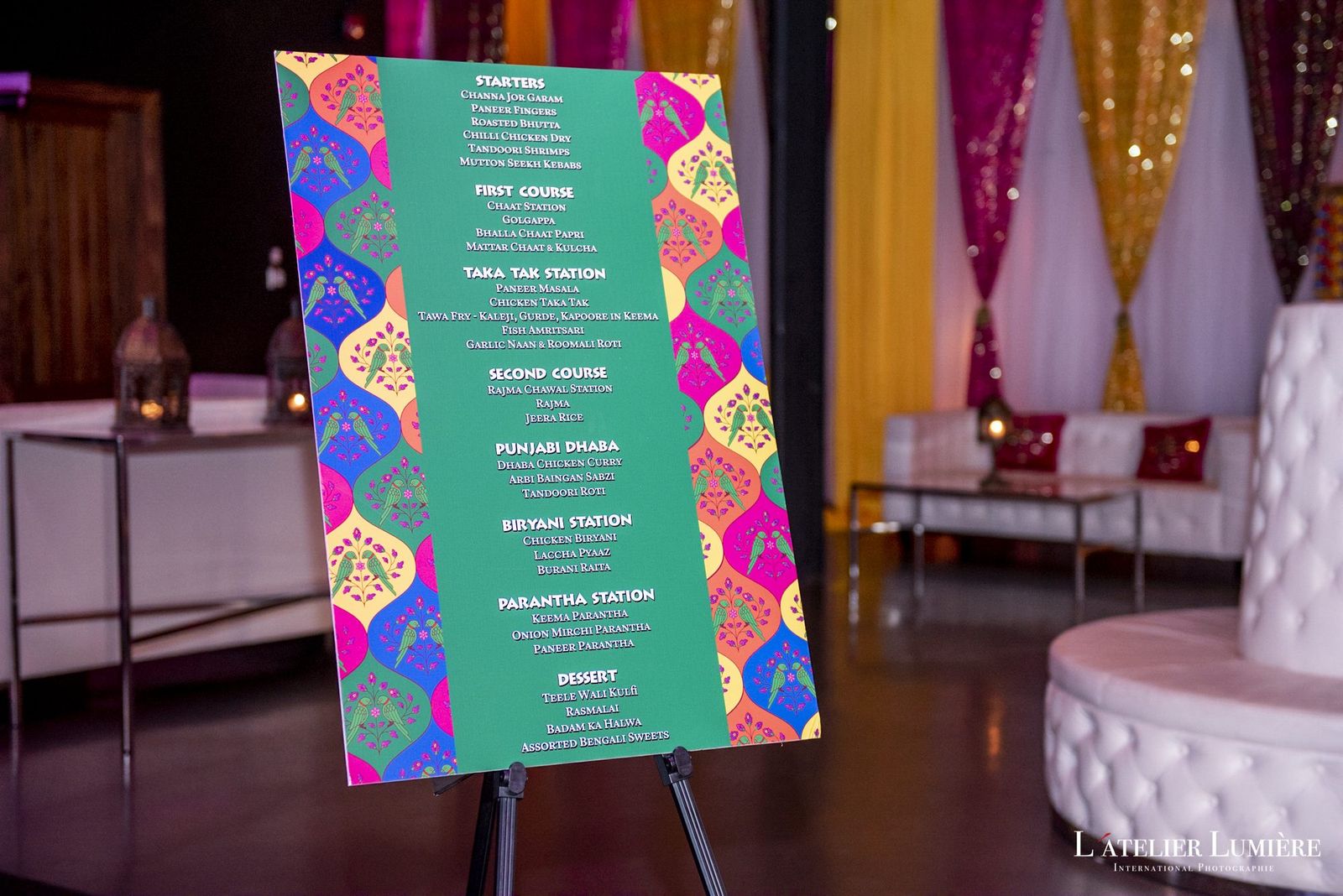 Colourful custom seating chart on an easel at a sangeet